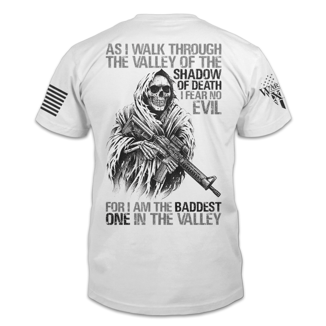 A white Baddest In The Valley t-shirt with the words" As I walk through the valley of the shadow of death, I fear no evil, for I am the baddest one in the valley", printed on the back.