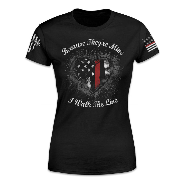 A black women's thin red line t-shirt with the words "Because they're mine I walk the line" printed on the front.